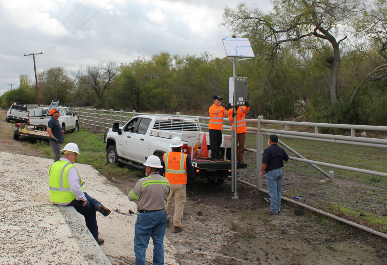 Group of workers installing a NextGen warning system