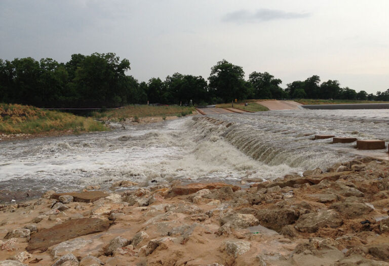 Mission Reach area flooded with rolling water over roadway